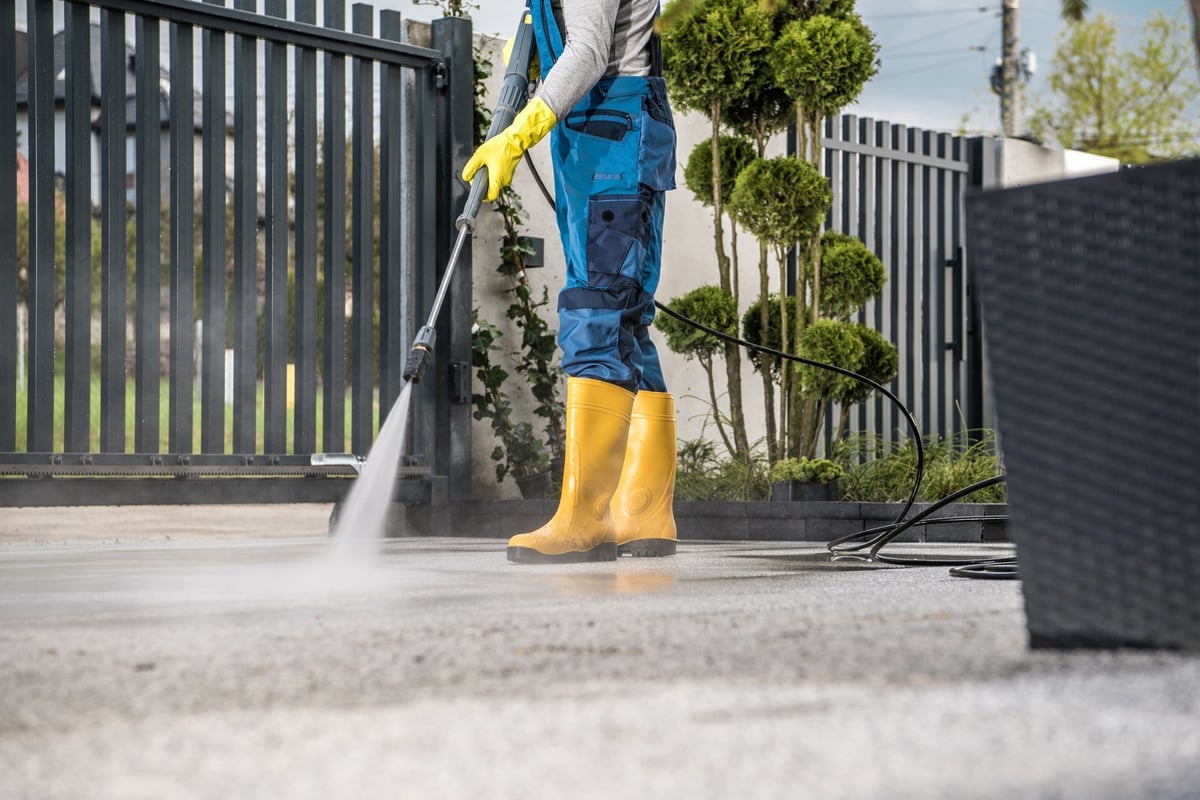 Professional pressure washing a driveway