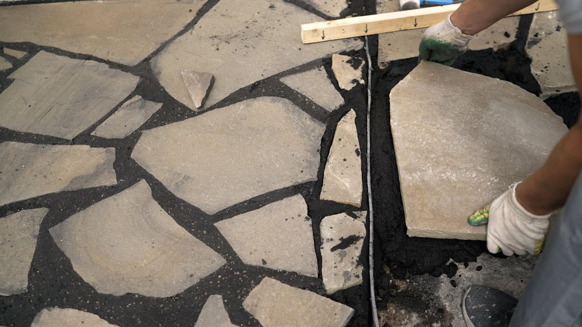 Hardscaping crew installing interlock pavers